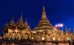 Long exposure photograph of ornate gold temple at night