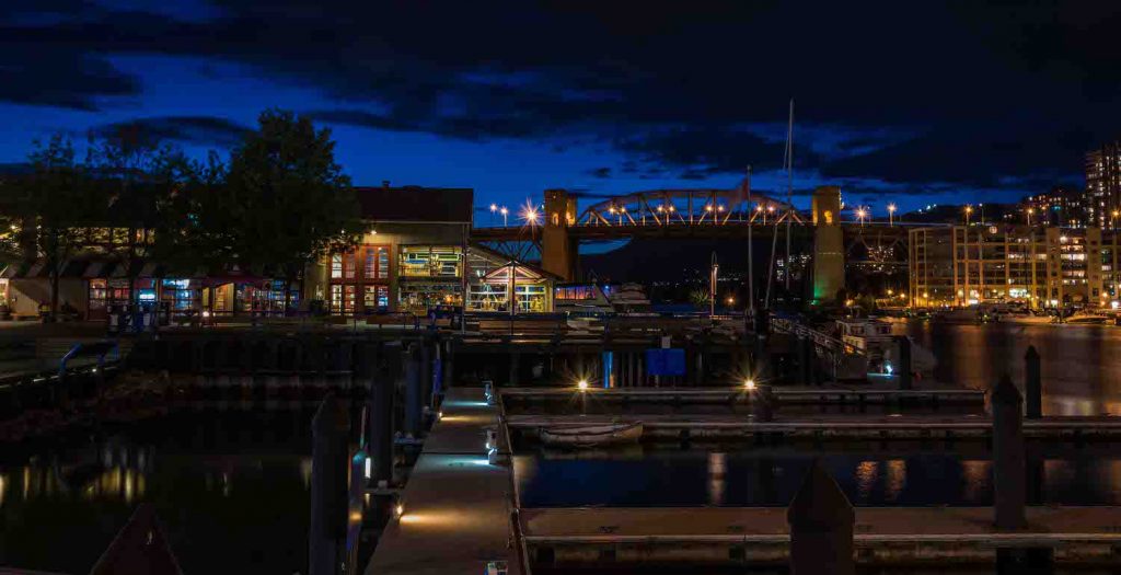 Night photograph of bridge over river with empty piers in city